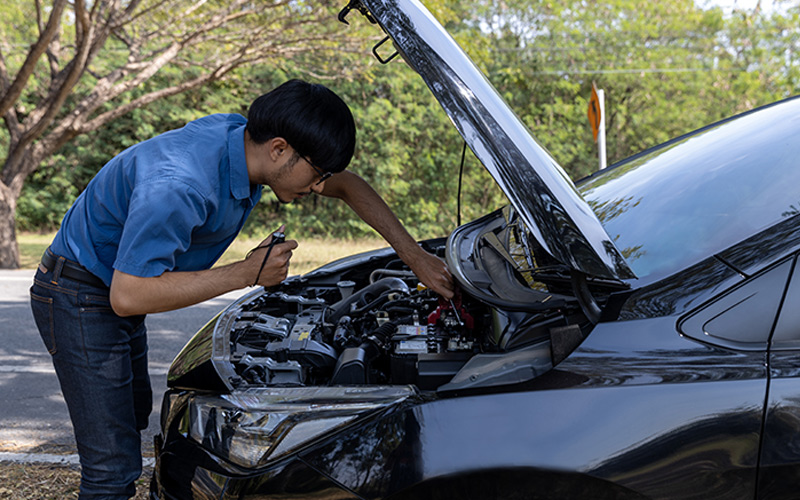 man checking car